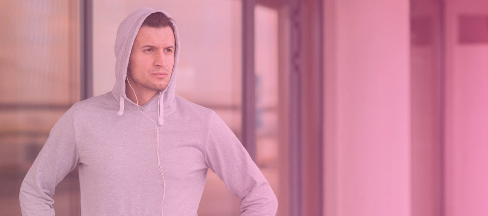 Man wearing stylish men's pullover hoodie in casual setting, showcasing comfort and modern design.